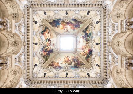 Symmetrical shot of the vault of a french building decorated with a fresco and a central skylight Stock Photo