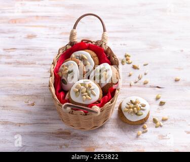 Fragrant Christmas gingerbread with glaze, nuts and seeds in a basket on a wooden background, free space, closeup, horizontal Stock Photo
