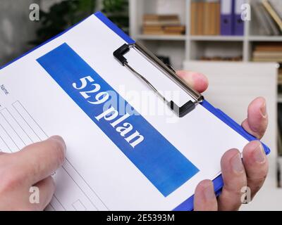 529 plan empty application in the hands. Saving for College concept. Stock Photo