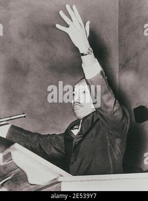 Martin Luther King, Jr., half-length portrait, facing left, with left arm raised, at freedom rally, Washington Temple Church. USA. 1962 Stock Photo