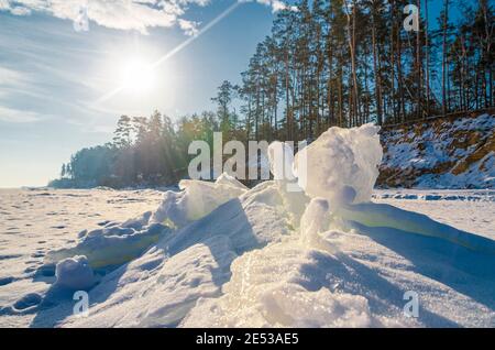 Ice hummocks on the winter sea shore. Sunny winter landscape. Stock Photo