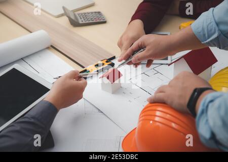 Engineer and Architect concept, Engineer Architects  and Interior designer working with blueprints Stock Photo