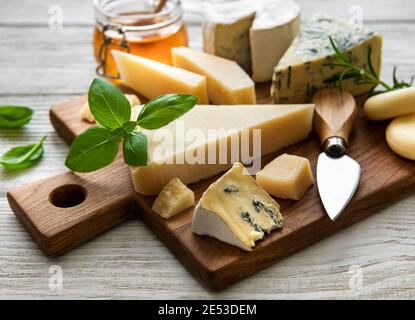 Various types of cheese  on a white wooden background Stock Photo