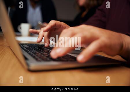 Close-up of a businessman's hand typing on laptop over the office desk Stock Photo