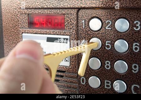 Person using contactless tool for press button to protect themselves from contracting coronavirus infection Stock Photo