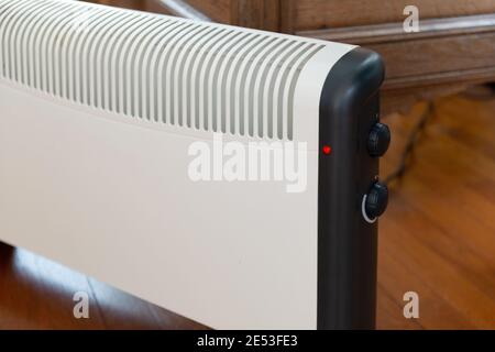 Close-up of an electric heater on parquet floor at home Stock Photo