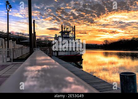 Montgomery, Alabama, USA - January 16, 2017: A view of the Harriett II Riverboat docked at Riverfront Park with a spectacular sunset over the Alabama Stock Photo