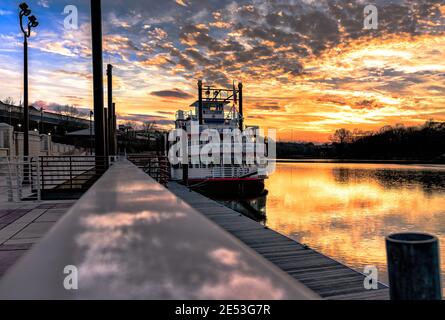 Montgomery, Alabama, USA - January 16, 2017: A view of the Harriett II Riverboat docked at Riverfront Park with a spectacular sunset over the Alabama Stock Photo