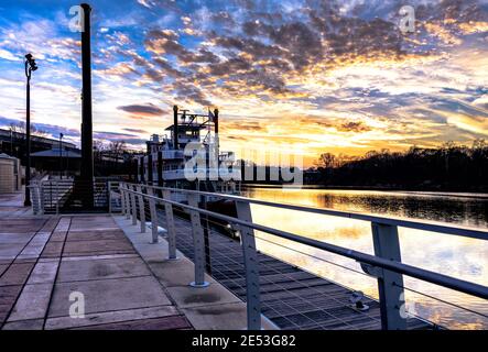 Montgomery, Alabama, USA - January 16, 2017: Harriott II riverboat docked at Riverfront Park in downtown Montgomery with a colorful sunset over the Al Stock Photo