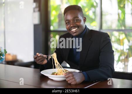 African businessman having a happy lunch Stock Photo