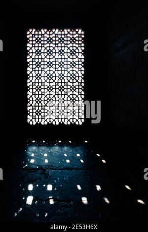 Light shining through stone window grill; India Stock Photo