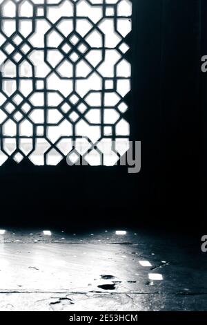 Light shining through stone window grill; India Stock Photo
