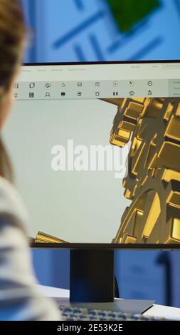 Focused woman architect working at new project using computer doing overtime at night sitting at desk in start-up office. Industrial female engineer studying on pc showing cad software in midnight Stock Photo