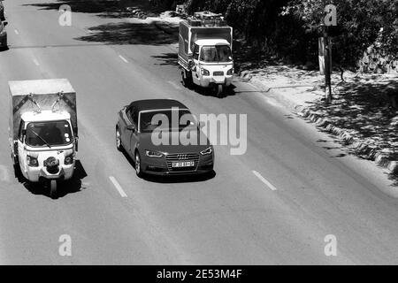 JOHANNESBURG, SOUTH AFRICA - Jan 06, 2021: Johannesburg, South Africa - October 19, 2014: Small TukTuk Grocery Store Home Delivery Vehicles driving th Stock Photo