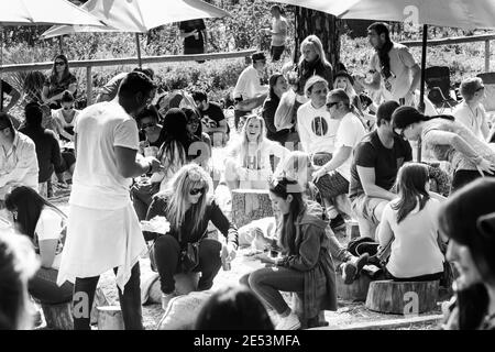 JOHANNESBURG, SOUTH AFRICA - Jan 05, 2021: Johannesburg, South Africa - May 24, 2015: Crowds of diverse people sitting in the beer garden at outdoor f Stock Photo
