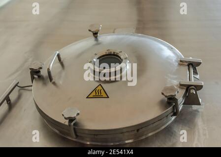 Hatch to the beer tank. Beer brewing tank at the factory Stock Photo