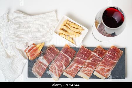 Spanish tapas, iberian loin, sausage. Iberian Acorn Ham and red wine Stock Photo