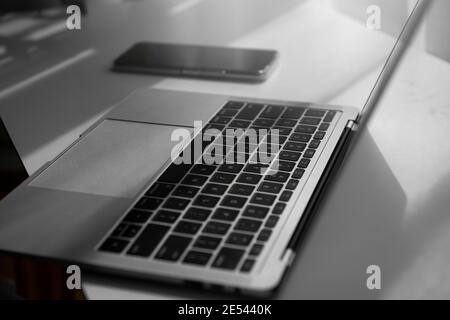 Phone with computer laptop on the table. Stock Photo