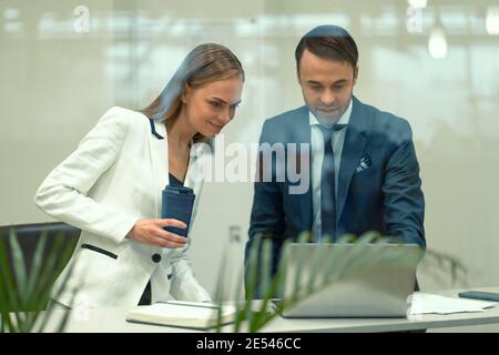 business partners negotiate at break in the street, pointing. business ...