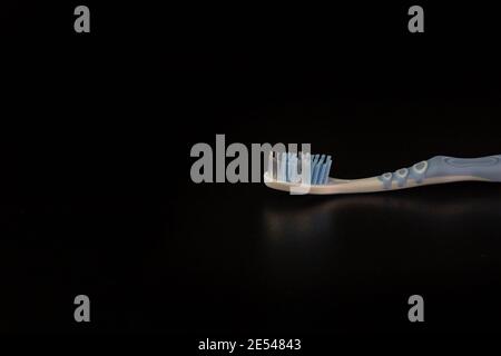 Selective focus on toothbrush isolated on black background. Stock Photo