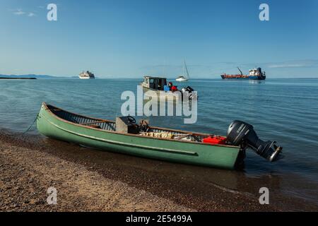 Green Inuit canoe with an engine by the beach in Pond Inlet Stock Photo