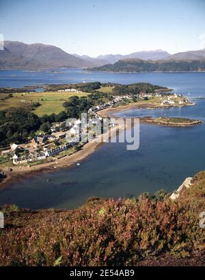 Scotland, Ross. Incoming tide on the crofting village of Plockton, nestling in a snug bay on Loch Carron. In the distance Applecross Hills at the head of Loch Kishorn.  Circa 1985. Photo by Tony Henshaw/Tom Parker Collection      Scanned from a 5'x4' Original transparency from a unique and stunning archive of original photography from the British Isles by photographer Tom Parker.    © World copyright. Stock Photo