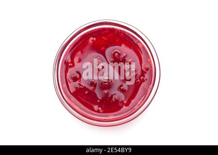 Raspberry jam in glass bowl, liquid jam isolated on white, top view, lay out with space for text Stock Photo