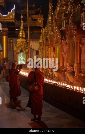 Two Buddhist Monks taking a picture with a tablet at the Shwedagon Pagoda, Yangon, Myanmar. Stock Photo