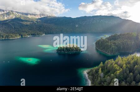 Aerial view of Eibsee lake island tree by Zugspitze before sunset in Germany Stock Photo