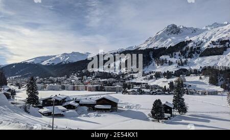 view into the valley of Davos Dorf including Parsenn with blue sky and plenty of snow Stock Photo