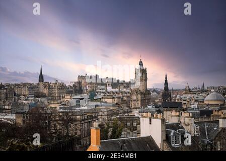 Scotland Edinburgh city centre looking from rooftops chimneys from high arial viewpoint dawn sunrise sunset town hall clock tower wide angle view Stock Photo