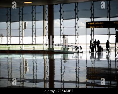 International airport in lockdown during Covid 19 pandemic waiting terminal for last aeroplane flight out of city centre runway home family silhouette Stock Photo