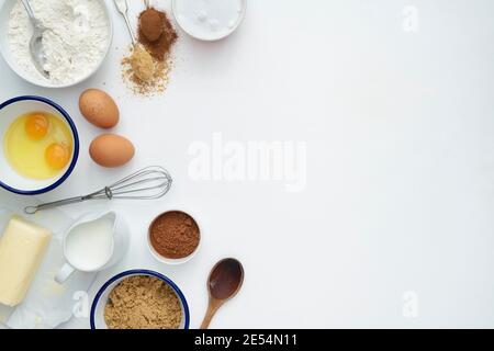 Baking ingredients and cooking utensils on a white wooden background Stock Photo