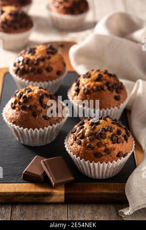 Just baked chocolate muffins on wooden table Stock Photo