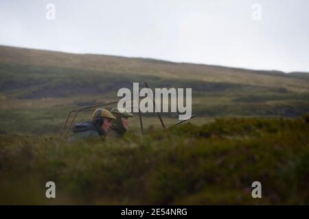 SCOTLAND Perth -- 21 Aug 2014 -- A loader and Mary Seldon wait for Red Grouse during a grouse shoot on the Glenturret Esate near Crieff in Perthshire, Stock Photo