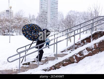 Boy with tubing climbs the steps. Winter fun. Stock Photo