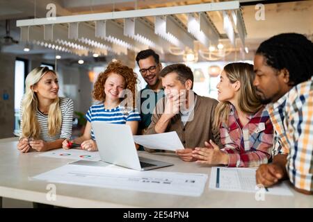 Creative brainstorming. Happy business people, designers, architects working as a team in office Stock Photo