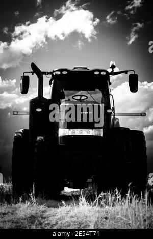 A black and white infrared image of a Case IH tractor on a may afternoon. Stock Photo