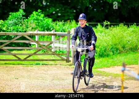 1940's Village policeman on bicycle Stock Photo