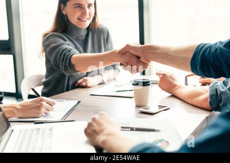 close up. smiling business woman shaking hands with her colleague . Stock Photo