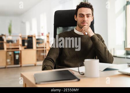 Entrepreneur working with a laptop and documents in an office Stock Photo
