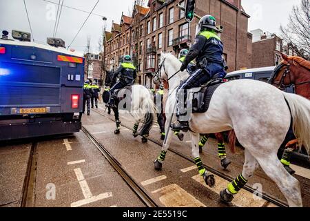 AMSTERDAM, NETHERLANDS, JANUARY 24: Riot police are seen near the Museumplein on January 24, 2021 in Amsterdam, Netherlands. Riots erupted after a for Stock Photo