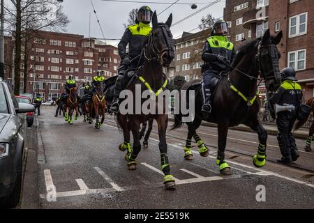 AMSTERDAM, NETHERLANDS, JANUARY 24: Riot police are seen near the Museumplein on January 24, 2021 in Amsterdam, Netherlands. Riots erupted after a for Stock Photo