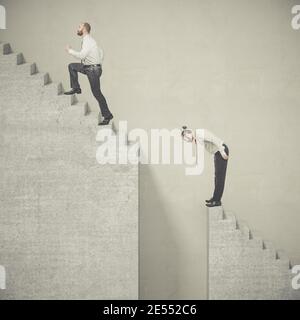 businessmen climb a ladder that presents difficulties. concept of success and adversity in the world of work. Stock Photo