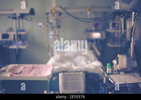 Critical care ward with patient in the bed, unfocused background. Stock Photo