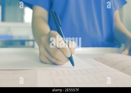 Female doctor examining medical card. Stock Photo