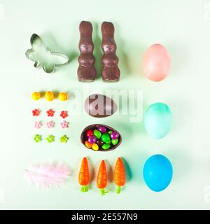 Easter set knolling eggs, carrots, chocolate bunny, cookie cutter, candies feather Stock Photo