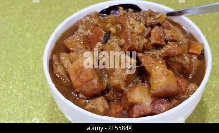 Red braised pork belly, served in a white bowl. Stock Photo