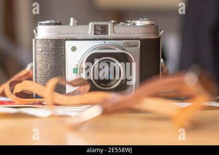 front on view of a Kodak Retinette film camera with a vintage leather strap. Stock Photo