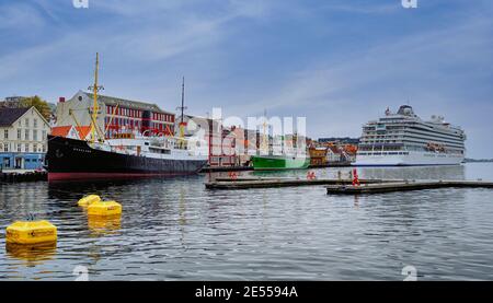 Stavanger Harbour in Norway with cruise ship moored with fishing boats Stock Photo
